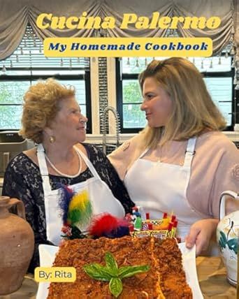 two women standing in front of a cake