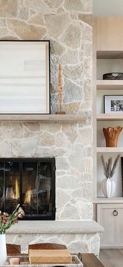 a living room filled with furniture and a fire place next to a wall mounted tv