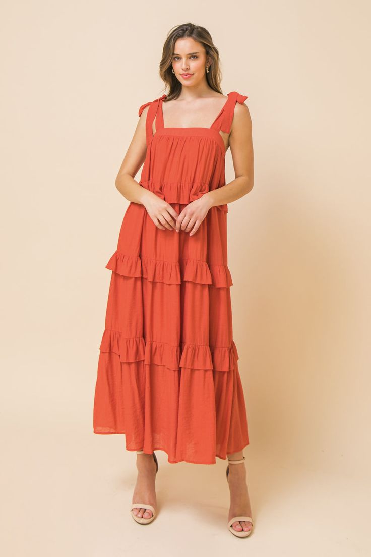 A textured woven maxi dress featuring straight neckline, shoulder tie and ruffled tiered bottom Details Self: 100% Polyester Lining: 100% Polyester Size & Fit - Model is 5`8" And Wearing Size Small - Measurements Taken From Size Small - Approx. Length: 45" Casual Maxi Dress With Straight Neckline For Brunch, Vacation Maxi Dress With Tie Straps And Straight Neckline, Casual Tiered Beach Dress With Adjustable Straps, Summer Maxi Dress With Tie Back And Straight Neckline, Vacation Midi Dress With Tie Straps And Straight Neckline, Beach Sundress With Square Neck And Ruffle Hem, Beach Sundress With Ruffle Hem And Square Neck, Vacation Midi Dress With Tie Back And Ruffled Straps, Spring Vacation Tiered Dress With Square Neck