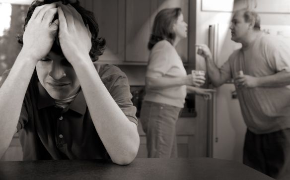 two people are standing in the kitchen and one is covering his eyes