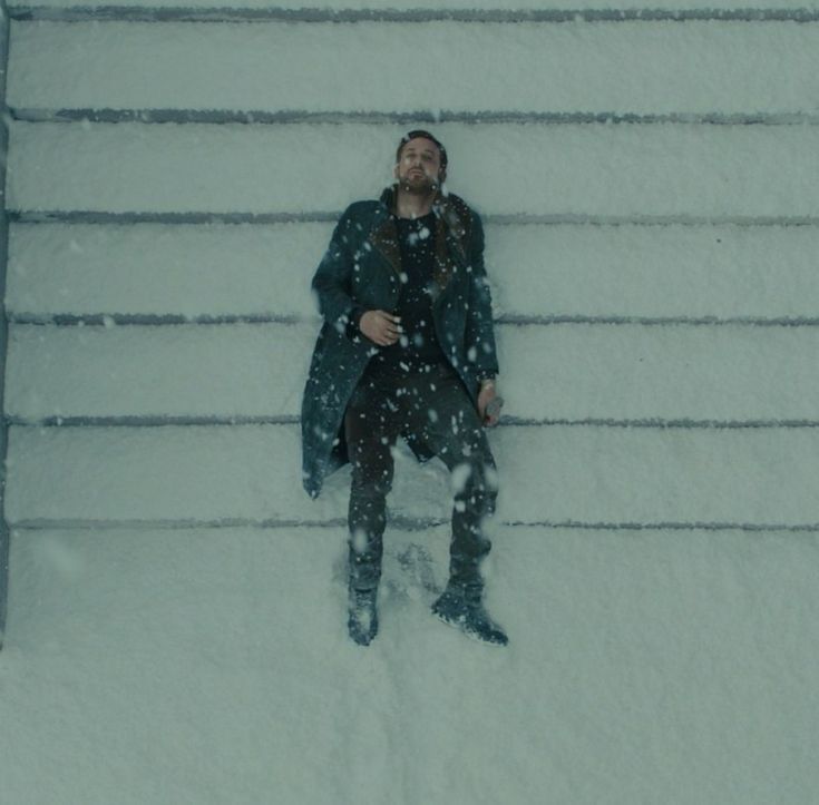 a man sitting on steps covered in snow