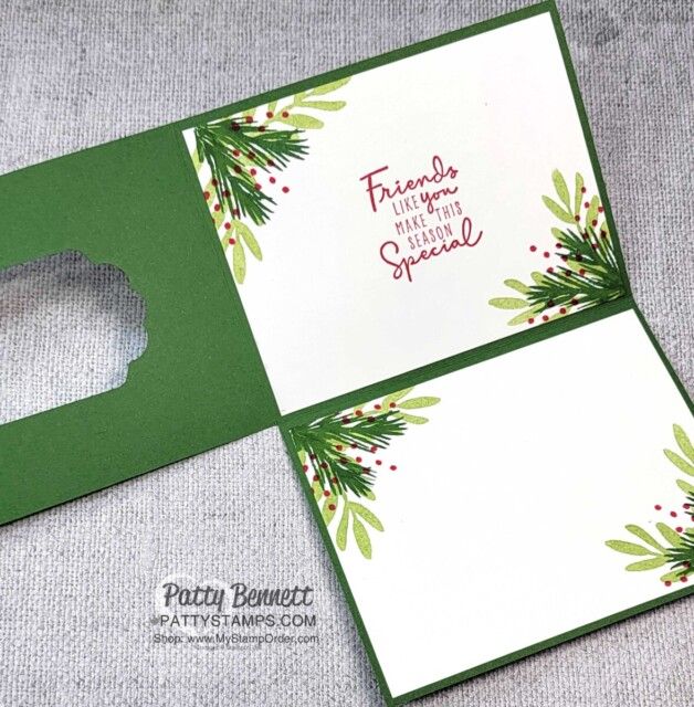 the inside of a christmas card with holly and berries on it, which is cut out into