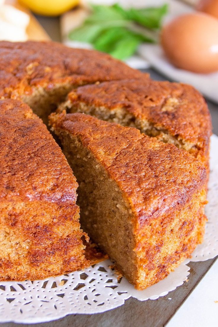 there is a cake that has been cut in half and on the table next to some eggs