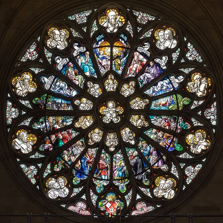 a large stained glass window in the middle of a building with many people on it