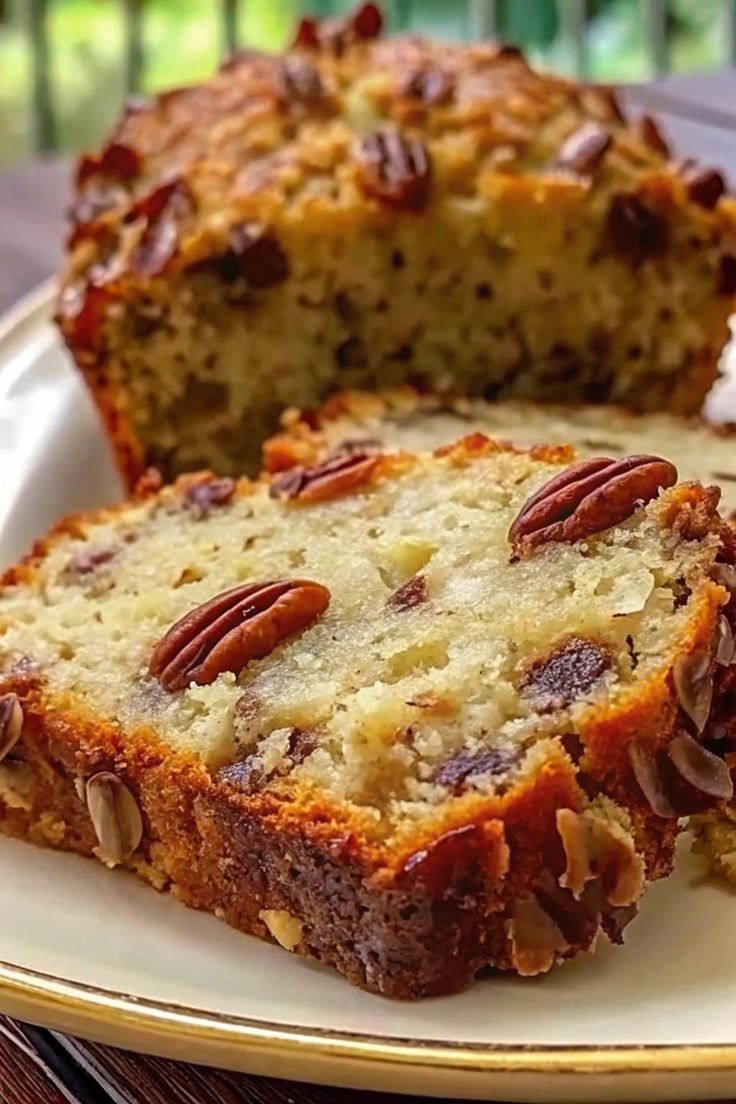 slices of banana bread on a plate with pecans