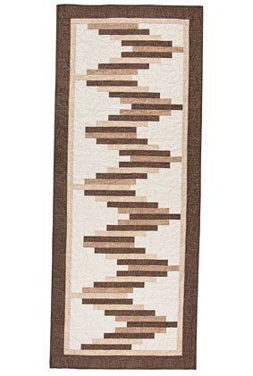 a brown and white rug with lines on it's side, in the shape of a rectangle