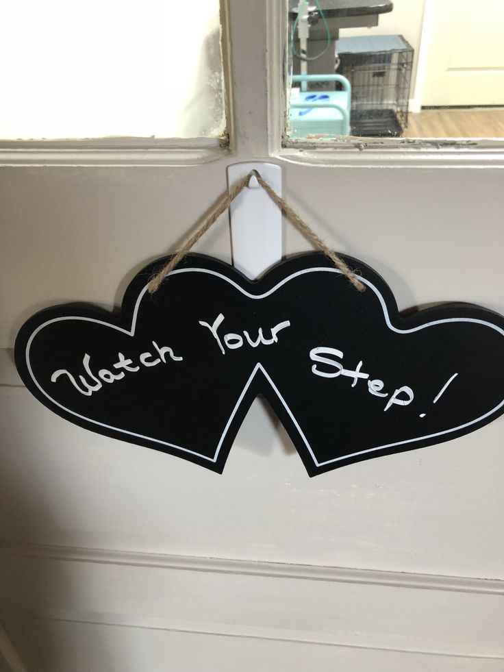 two black hearts hanging on a door hanger that says, attach your step up