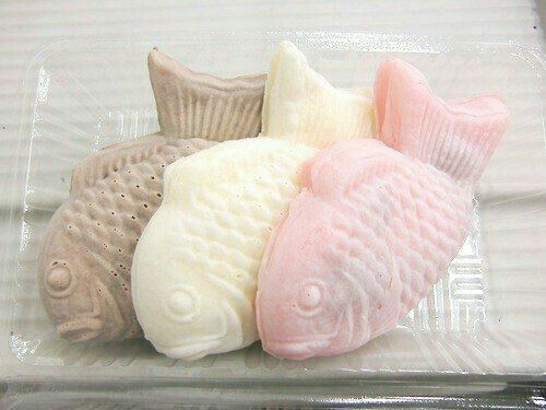 three different colored fish shaped soaps in a package