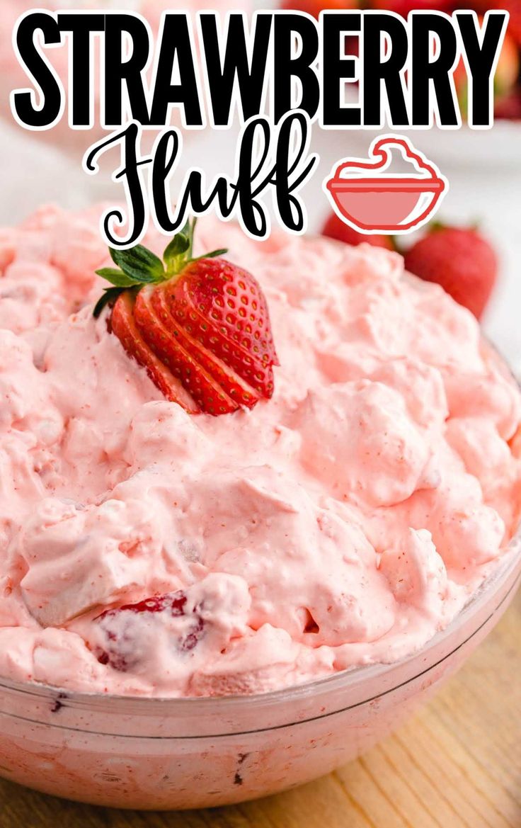 a bowl filled with strawberry fluff sitting on top of a wooden table