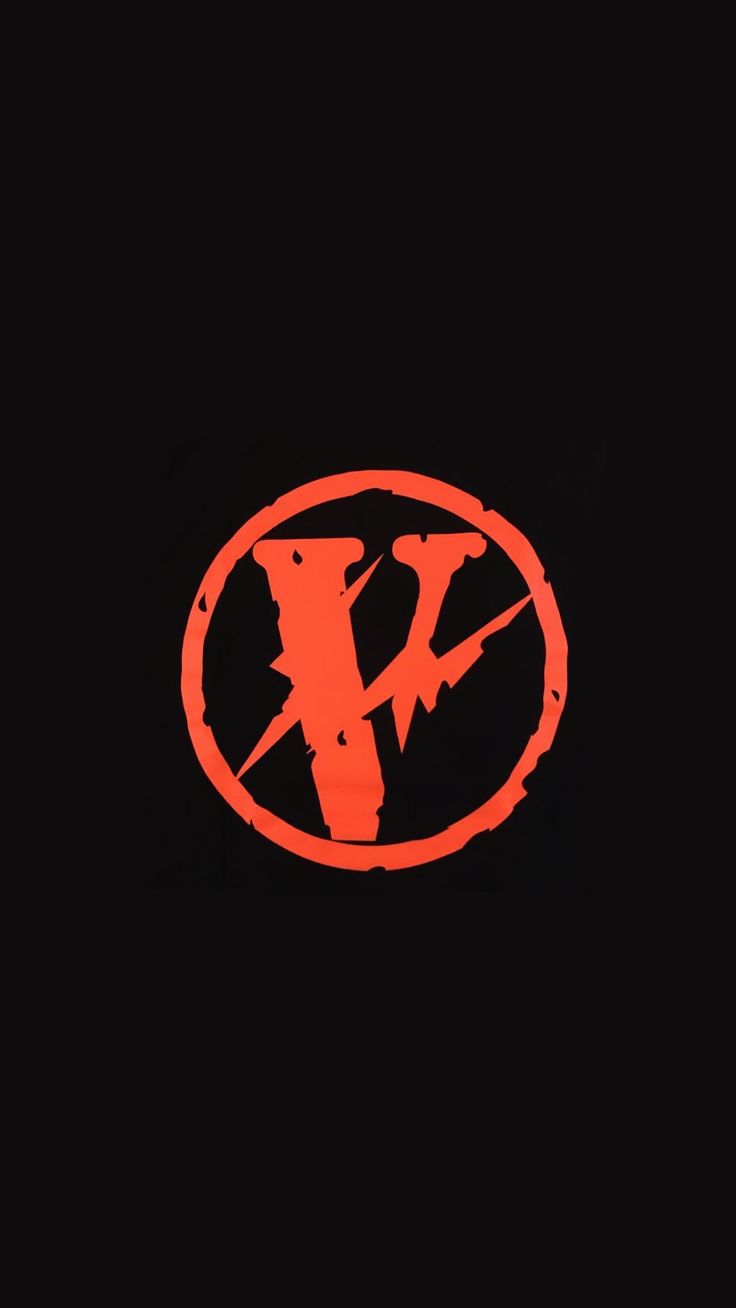 an orange and black logo on a black background