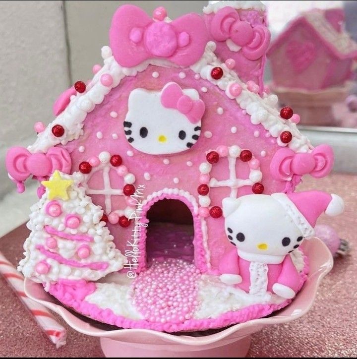 a pink hello kitty doll house on top of a table