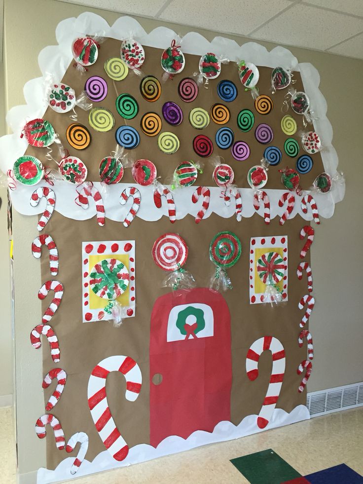 a gingerbread house decorated with candy canes and lollipops for christmas