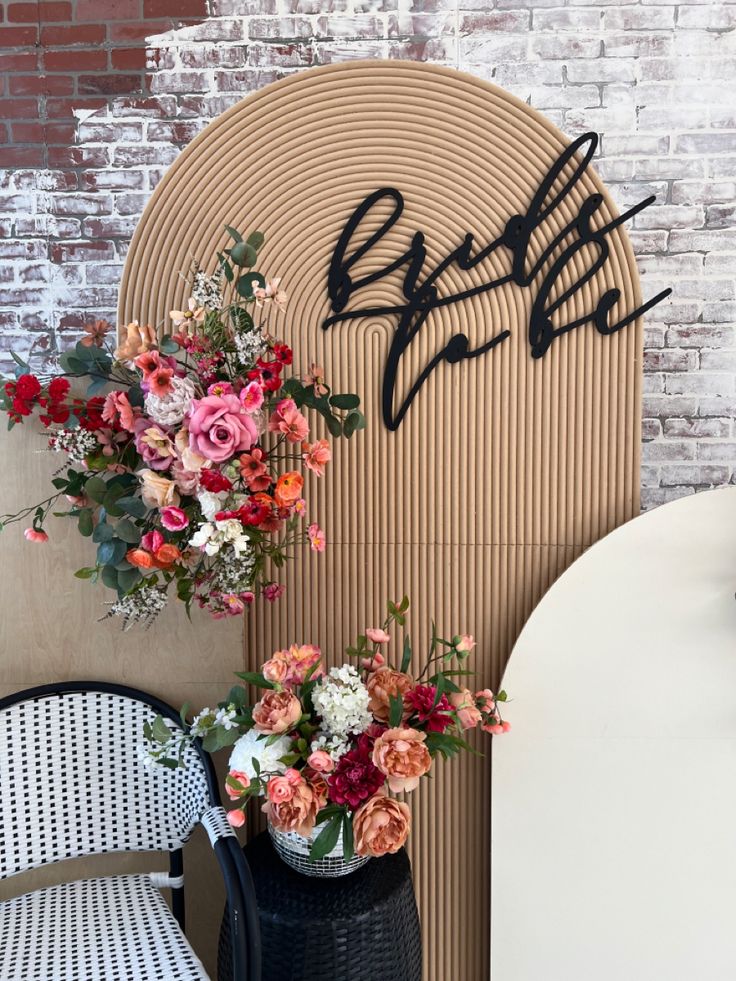 flowers are sitting in vases next to a sign that says bridal on it