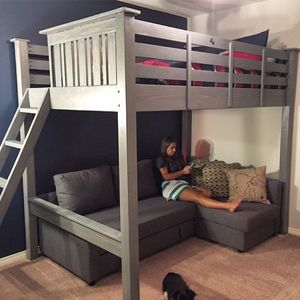 a person sitting on a couch under a bunk bed