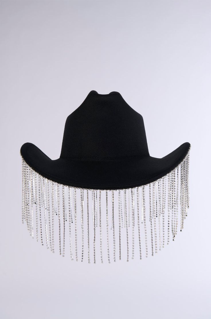 Get rambunctious at the rodeo in The AKIRA Label Lets Get Rowdy Bling Cowboy Hat. This glamorous Western accessory features a felt-like base, a tall dimpled crown, a classic upturned brim, faux silver metallic hardware, and sparkling rhinestone link fringe along the brim’s perimeter. Style with faux leather chaps and a sleek corset for a festival-ready ensemble.  - 65% Cotton 35% Polyester (all measurements are approximate from size O/S) - 22” Head Circumference, 44” Outer Brim Circumference  - 4.75” Fringe Length  - Imported Product ID: 394562 Leather Chaps, Western Accessories, Cowboy Hat, Head Circumference, Cowboy Hats, Metallic Silver, Cowboy, Faux Leather, Felt