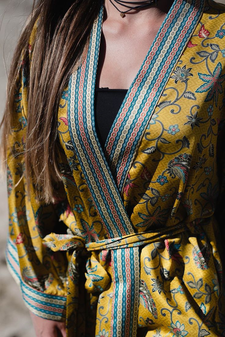 The perfect gift for anyone who loves the finer moments in life, this soft and sexy kimono robe is crafted by hand with strong attention to detail. With a gorgeous print and exclusive stitches, it's perfect for an extended variety of use. Elevate your kimono experience with the luxurious touch of our blended silk viscose fabric. This exquisite material harmoniously combines the elegance of silk with the comfort of viscose, resulting in a fabric that drapes effortlessly and exudes a subtle sheen. Long Printed Kimono For Loungewear, Printed Long Sleeve Festival Robe, Traditional Spring Floral Robe, V-neck Patterned Kimono For Festival, Printed Long Sleeve Kimono For Loungewear, Multicolor Floral Print Wrap Robe, Printed Kimono With Kimono Sleeves For Loungewear, Bohemian Printed Wrap Robe, Multicolor V-neck Kimono For Loungewear