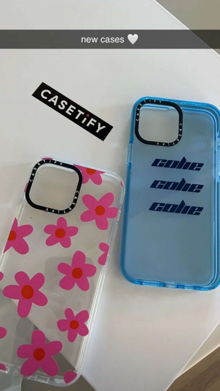 two cases sitting next to each other on top of a white table with pink and blue flowers