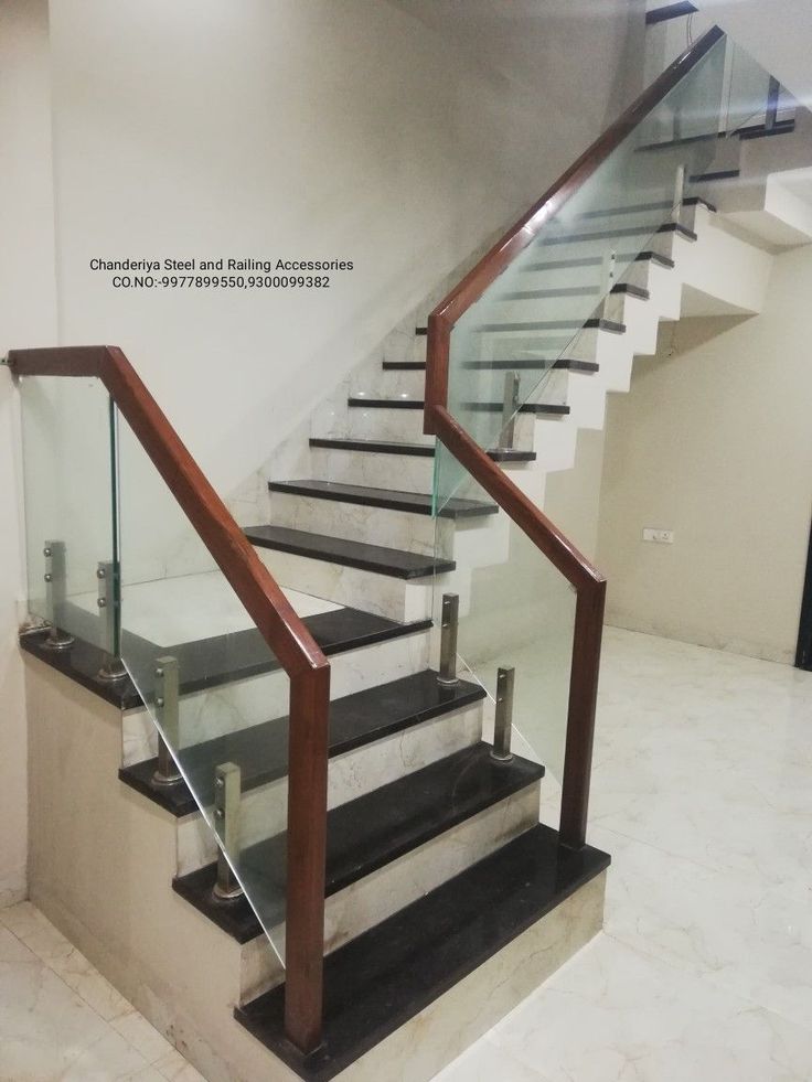 a set of stairs with glass railings