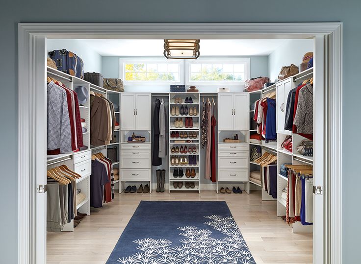 a walk in closet with an area rug on the floor