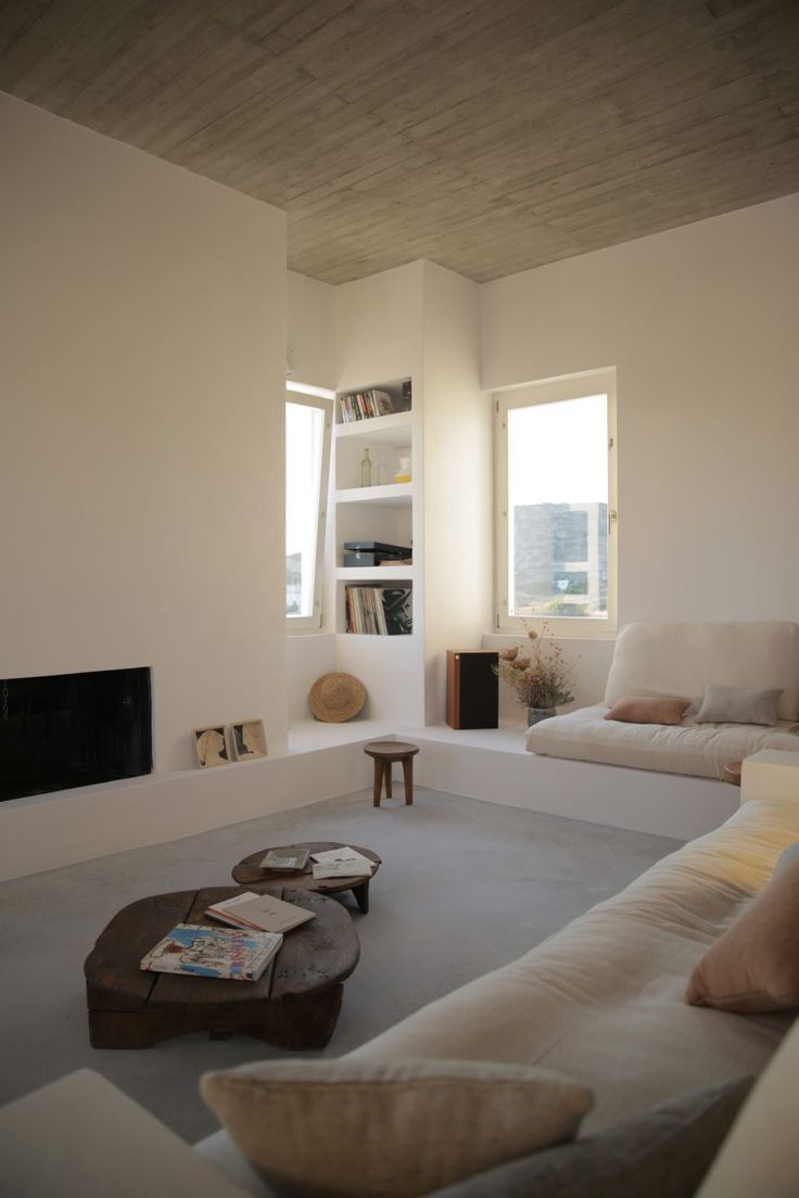 a living room filled with furniture and a fire place