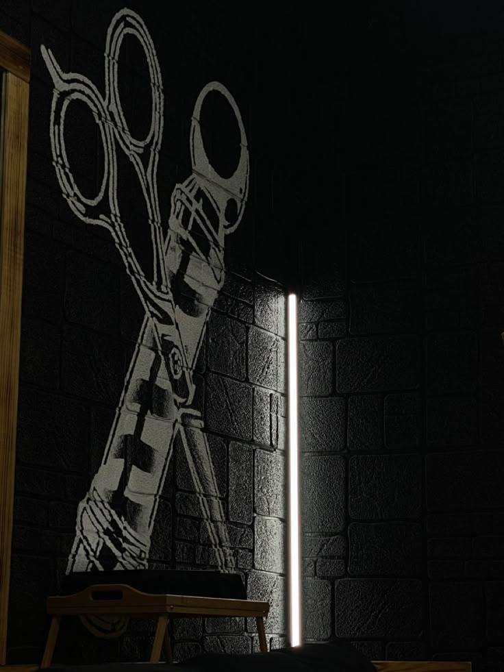 a pair of scissors sitting on top of a table in front of a brick wall