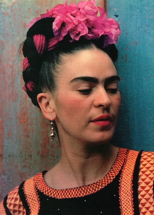 a woman with pink flowers in her hair