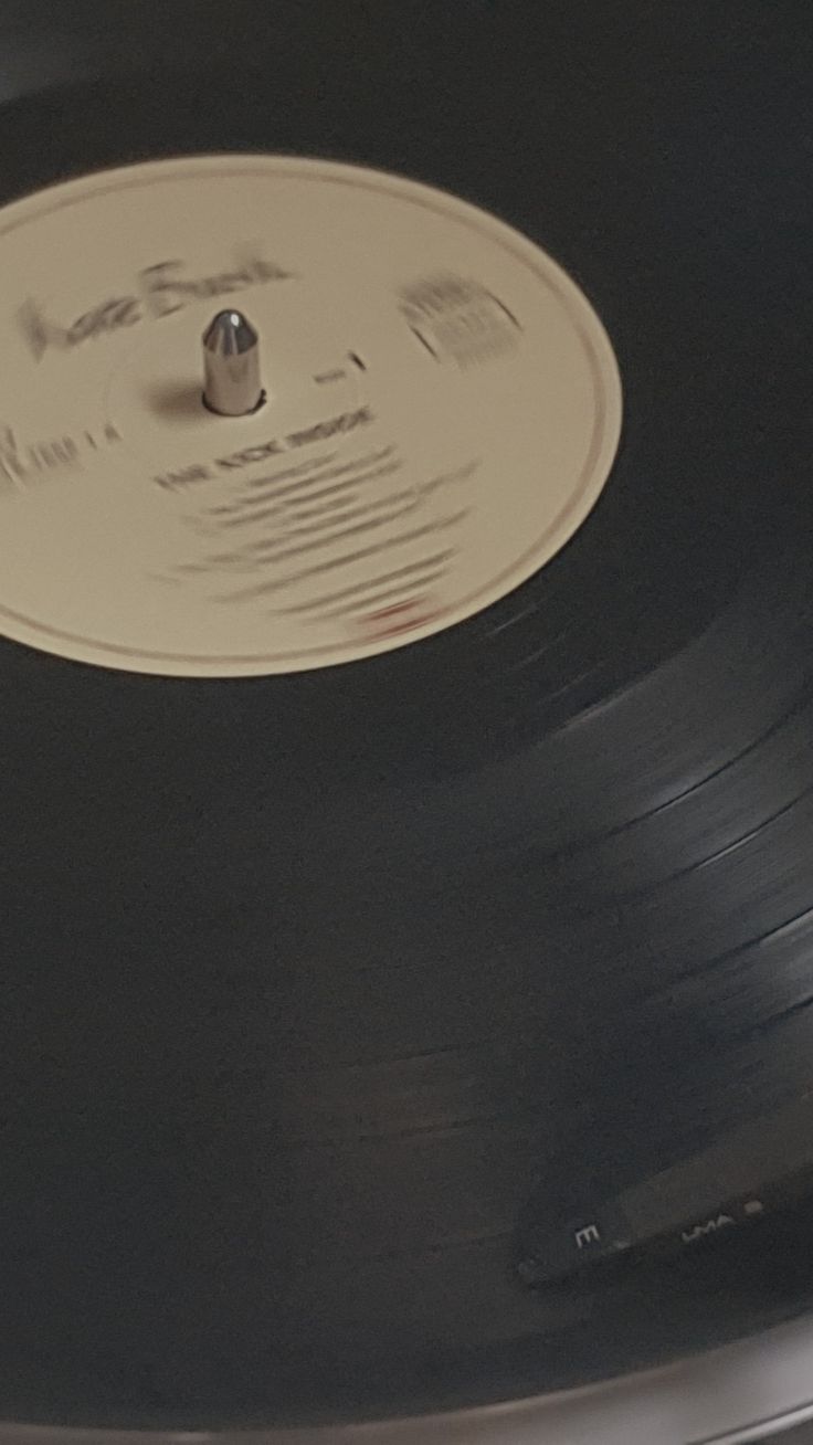 an old record player is sitting on top of the turntable with its lid open