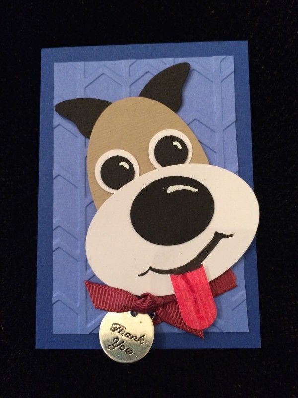 a card with a dog's face on it and a red ribbon around its neck