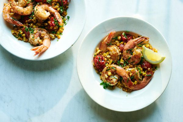 two white bowls filled with food on top of a table