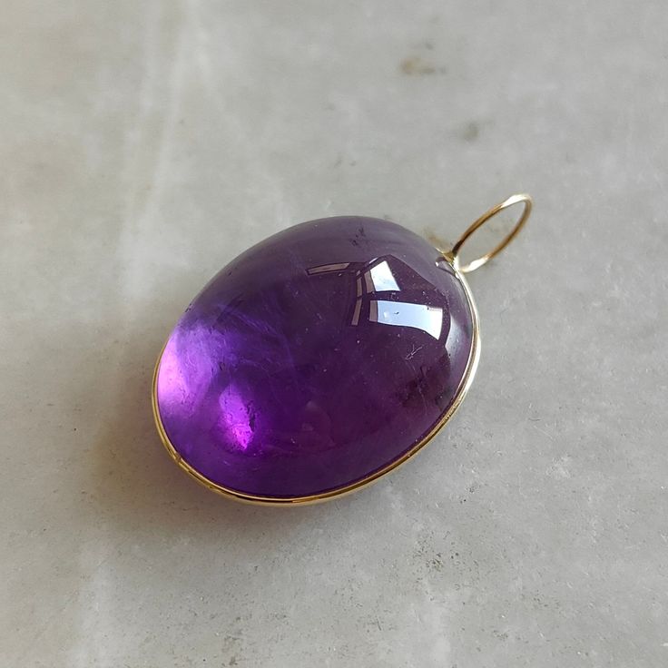 This stunning Pendant is set in 14k Solid Yellow Gold with Natural Purple Amethyst with utmost precision. It is a unique gemstone Pendant for nearly every occasion and is completely hassle-free jewelry. ITEM DETAILS: * Gem: Purple Amethyst * Gem Size: 20x25mm * Gem Shape: Oval Fix Loop * Gem Weight: 41.25 carats * Gold Purity: 14KT  * Gold Weight: 0.47 gram * Total Weight of the Pendant: 8.72 gram The Gold purity is guaranteed and it comes with authentic 14KT gold hallmark. Since my items are ha Formal Amethyst Oval Cabochon Jewelry, Formal Amethyst Jewelry, Oval Cabochon, Elegant Amethyst Cabochon Gemstones, Elegant Cabochon Amethyst Gemstones, Polished Amethyst Gemstones For Formal Occasions, Formal Polished Amethyst Gemstones, Formal Purple Cabochon Gemstones, Fine Amethyst Jewelry With Polished Finish, Purple Cabochon 14k Gold Jewelry