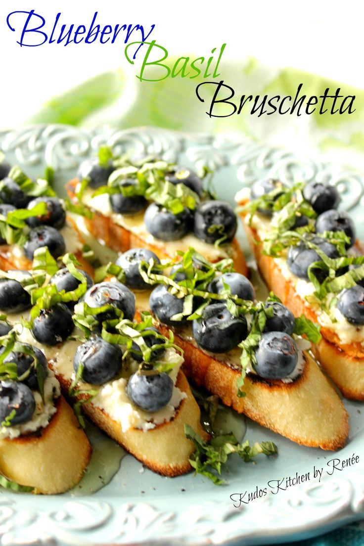 blueberry basil bruschetta is served on a white plate with green garnish