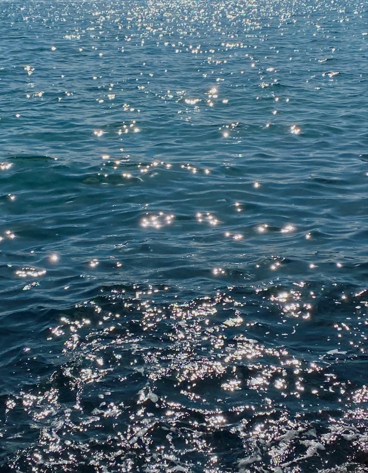 the sun shines brightly on the water as it reflects off the surface of the ocean