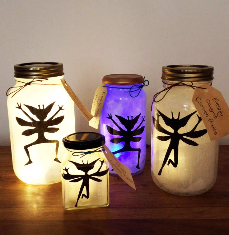 three mason jars with painted bugs on them