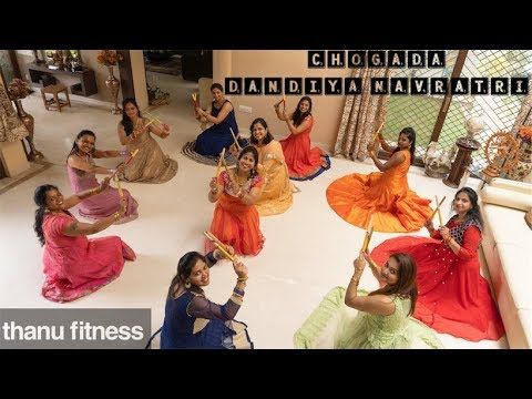 a group of women sitting on top of a white floor in front of a mirror