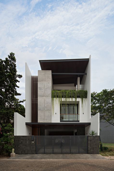 the modern house is surrounded by trees and plants