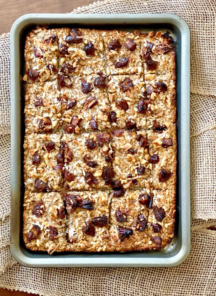 a pan filled with oatmeal and raisins on top of a table