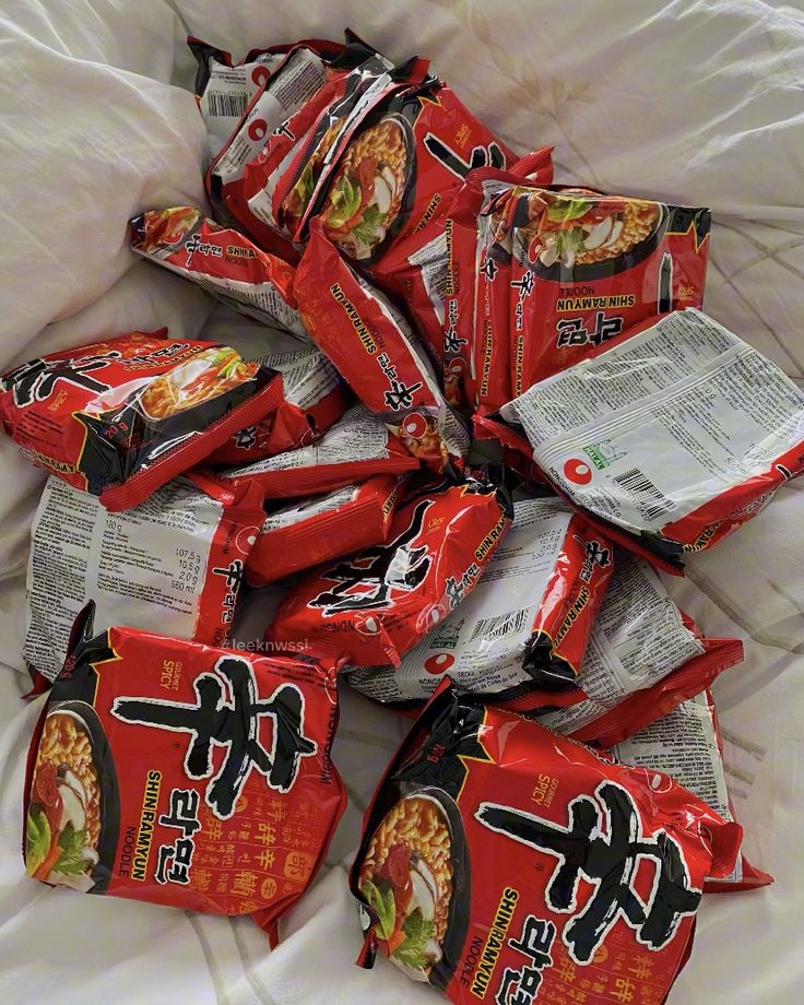 a pile of chinese snacks on top of a bed