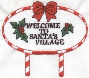 a sign that says welcome to santa's village with candy canes on it