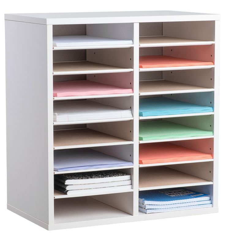 a white shelving unit filled with files and folders