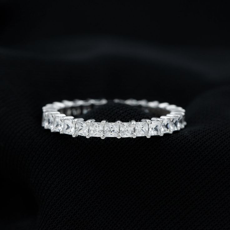 Product Details Full Eternity Ring is encased with sparkling Princess Cut Zircon in the Shared Prong Setting makes a beautiful band. This Zircon Full Eternity Ring is composed of Solid Gold metal. Product Information SKU SHP-RINGS102022803 Width 1.4 mm Height 2 mm Weight 1.60 gm (Approximate) ZIRCON INFORMATION No.of Stones 29 Pieces Total Weight 1.60 Carat (Approximate) Dimension(approx) Princess Cut-2X2 mm-29 Pcs Color White Cut Brilliant Shape Princess Cut Setting Type Shared-Prong-Setting Qu Princess Cut Moissanite, Wedding Anniversary Rings, Full Eternity Ring, Eternity Band Ring, Signature Jewelry, Timeless Jewelry, Princess Cut, Conflict Free Diamonds, Eternity Bands