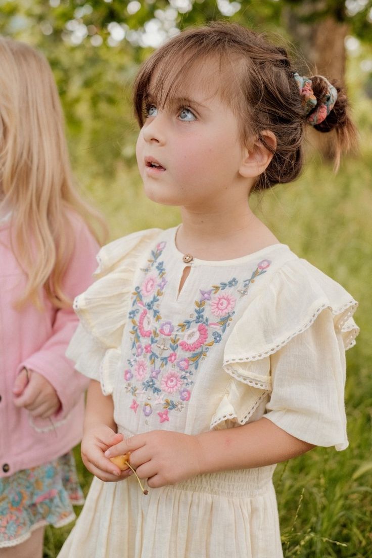 There’s something classically elegant about this Louise Misha Dress. Perfect for creating a timeless dressed-up outfit, intricate embroidery makes a statement against the luxuriously soft neutral fabric. Ruffles and stretchy smocking at the waistband make it as cute as it is comfortable. 75% Organic Cotton, 25% Linen. Spring Cream Dress With Ruffle Sleeves, Cream Ruffle Sleeve Dress For Spring, Cream Spring Dress With Embroidered Hem, Fabric Ruffles, Neutral Fabric, Louise Misha, Baby Boy Accessories, Kids Artwork, Boys Swim