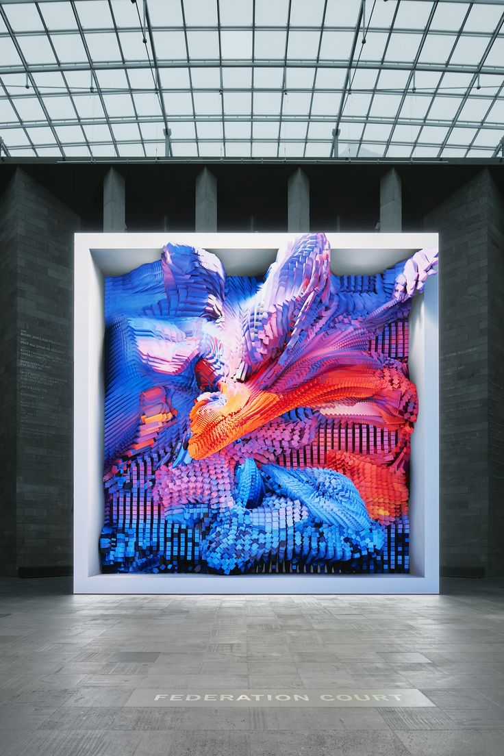 an abstract painting on display in a large room