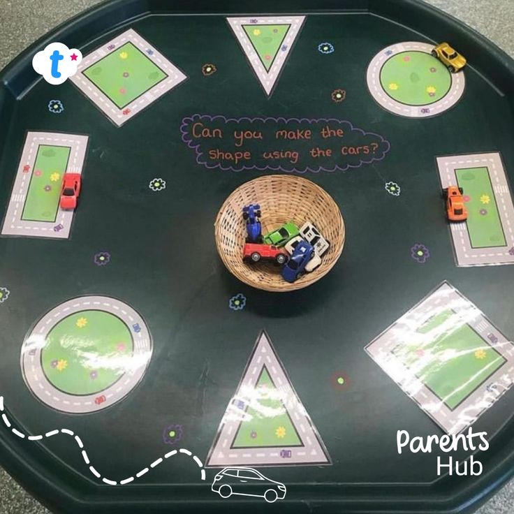 a child's play table with cars and shapes on it