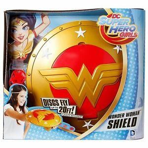 the dc super hero girls wonder woman shield is shown in its packaging, and it's gold