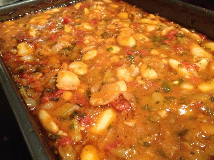 a casserole dish filled with beans and vegetables