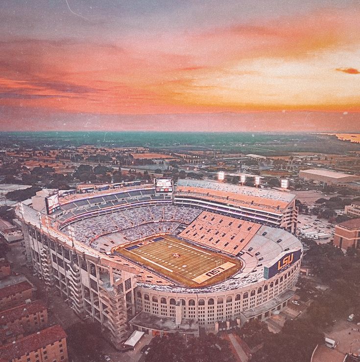 an aerial view of a football stadium at sunset