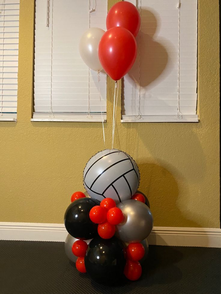 some balloons that are in the shape of volleyballs