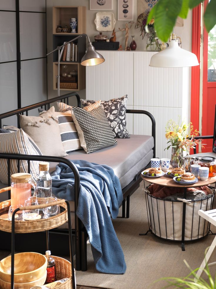 a living room filled with furniture and lots of pillows on top of it's covers