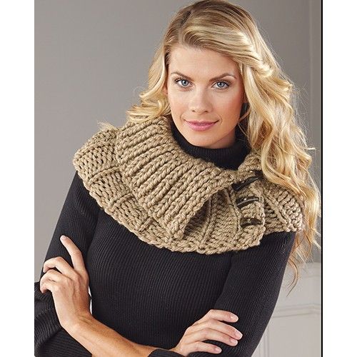 a woman wearing a knitted cowl neck scarf and black turtle - neck sweater