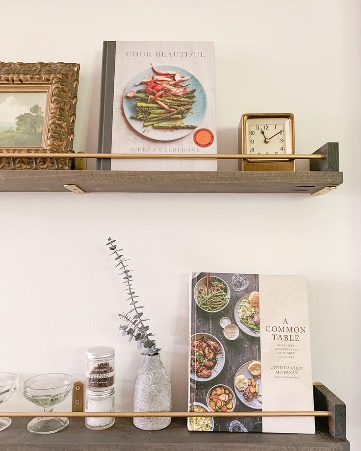 two shelves with books and other items on them